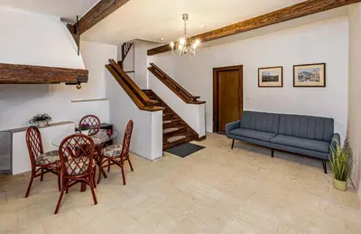 a living room with a couch and a table and chairs at Penzion Popelka in Roudnice nad Labem