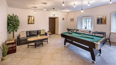 a living room with a pool table and a couch at Penzion Popelka in Roudnice nad Labem