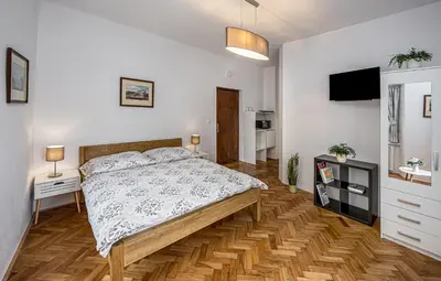 a bedroom with a bed and a television in it at Penzion Popelka in Roudnice nad Labem