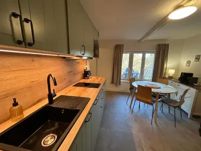 a grill sitting on the grass in the yard at Cosy chalet with wellness in Mirošovice