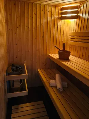 a swing chair in a room with a lamp at Cosy chalet with wellness in Mirošovice