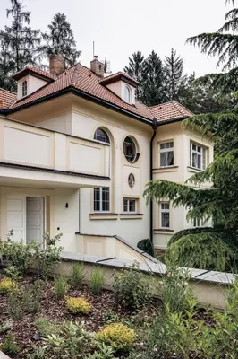 a white house with a red roof at Vila Zlatý Slavík - Luxurious Villa with Spa in Jevany