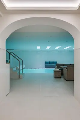 an empty lobby with a blue ceiling and a glass floor at Vila Zlatý Slavík - Luxurious Villa with Spa in Jevany
