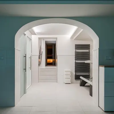 an archway leading into a bathroom with a staircase at Vila Zlatý Slavík - Luxurious Villa with Spa in Jevany