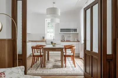 a kitchen with a dining room table and chairs at Vila Zlatý Slavík - Luxurious Villa with Spa in Jevany