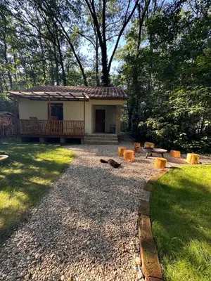 a small house with a porch and a yard at Chatinka Kersku in Hradišťko