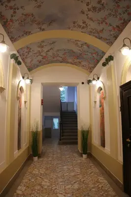 a hallway with a floral ceiling in a building at Arbes 20 - Family Suite in Prague