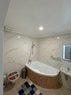 a bathroom with a bath tub and a sink at Arbes 20 - Family Suite in Prague