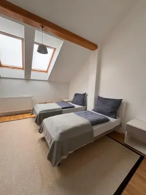 a bedroom with two beds and a window at Arbes 20 - Family Suite in Prague