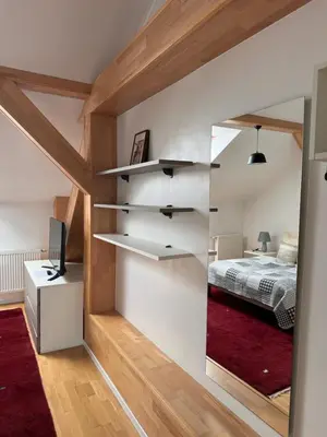 a room with a bed and a mirror at Arbes 20 - Family Suite in Prague