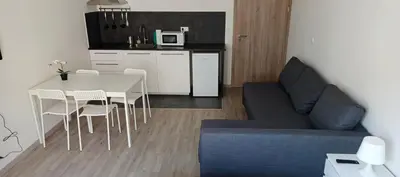 a living room with a table and a blue couch at Brand new two room apartment #23 with FREE parking in the city center in Prague