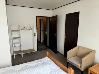 a bedroom with a bed and a chair and a mirror at Rodinný dům Poděbrady in Poděbrady
