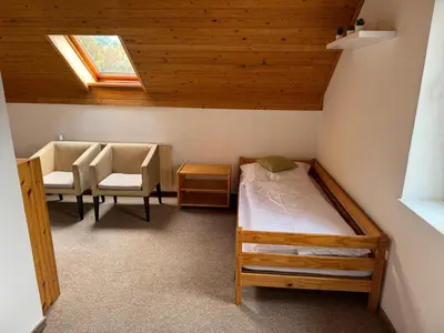 a bedroom with a bed and a table and chairs at Rodinný dům Poděbrady in Poděbrady