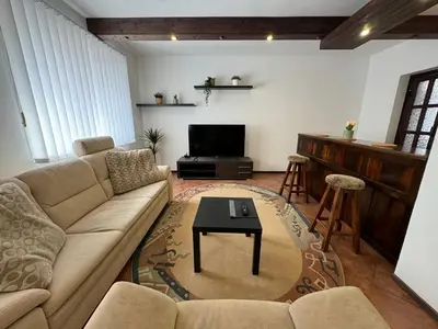 a living room with a couch and a tv at Rodinný dům Poděbrady in Poděbrady