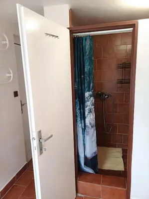 a shower with a glass door in a bathroom at Bruno in Postřižín