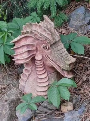 a bird statue is sitting on the ground at Bruno in Postřižín