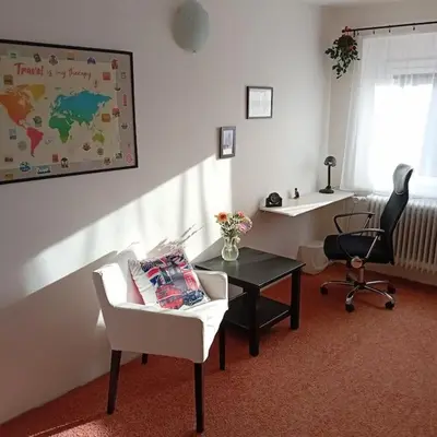 a living room with a desk and a chair and a table at Bruno in Postřižín