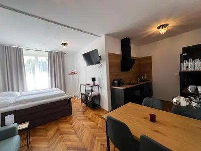 a living room with a bed and a table at Apartmán II centrum Praha in Prague