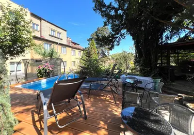 a patio with chairs and a table and a pool at Apartmán II centrum Praha in Prague