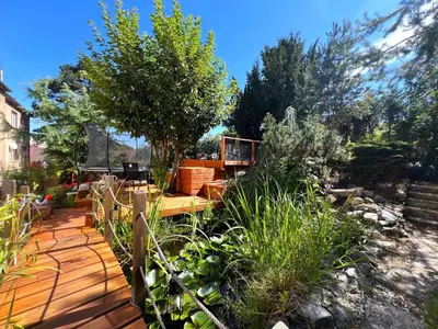 a garden with a wooden deck with plants at Apartmán II centrum Praha in Prague