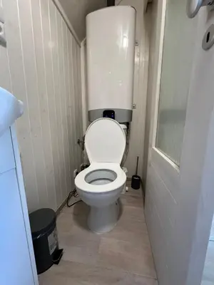 a bathroom with a white toilet in a stall at Maringotka u lesa in Staňkovice