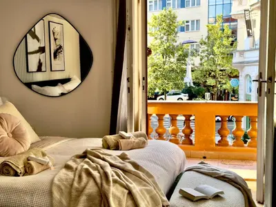 a bedroom with a bed and a window with a view at Rentero Modern High Ceiling Loft with Terrace Apartment, Prague in Prague