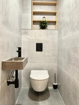 a bathroom with a toilet and a sink at Rentero Modern High Ceiling Loft with Terrace Apartment, Prague in Prague
