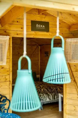 two green lights hanging from the ceiling of a cabin at Ostende - Chatky u Sázavy in Chocerady