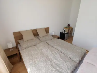 a bedroom with a large bed with pillows at Pension Nad Zlichovem in Prague