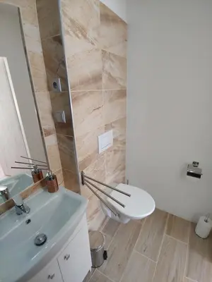 a bathroom with a white toilet and a sink at Pension Nad Zlichovem in Prague