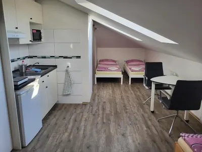 a small kitchen with a table and chairs in a room at Komárov Apartment in Beroun