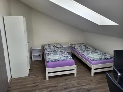 a room with two beds and a window at Komárov Apartment in Beroun