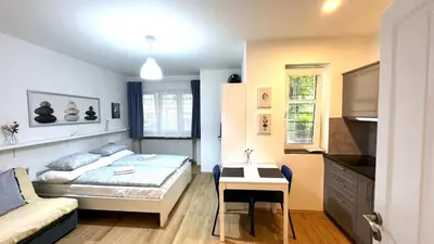 a bedroom with a bed and a desk in it at Hillside Studios in Prague