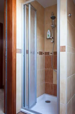 a shower with a glass door in a bathroom at U Prejzků in Lhotka