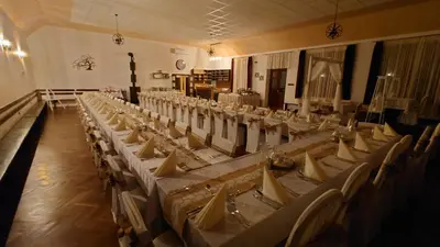 a row of tables and chairs in a banquet hall at U Prejzků in Lhotka