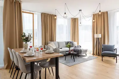 a living room with a table and a couch at Prague Days - Two-bedroom Apartment with Balcony and Garage Parking in Smíchov in Prague