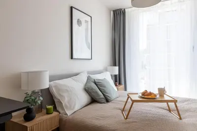 a bedroom with a bed with a coffee table at Prague Days - Two-bedroom Apartment with Balcony and Garage Parking in Smíchov in Prague