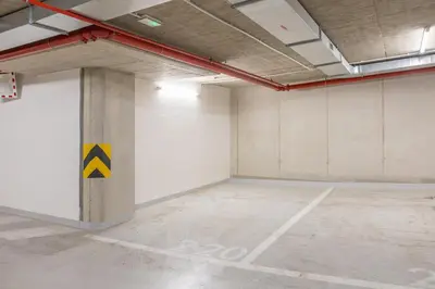 an empty room with a pillar with a yellow sign on it at Prague Days - Two-bedroom Apartment with Balcony and Garage Parking in Smíchov in Prague