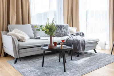 a living room with a couch and a table at Prague Days - Two-bedroom Apartment with Balcony and Garage Parking in Smíchov in Prague