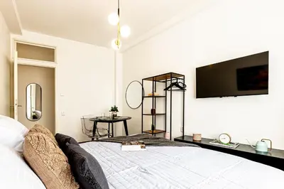 a bedroom with a bed with a tv on the wall at Prague Days - Studio with Netflix in Old Town in Prague