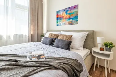 a bedroom with a bed and a painting on the wall at Prague Days - Studio with Netflix in Old Town in Prague