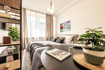 a living room with a table and a couch at Prague Days - Studio with Netflix in Old Town in Prague