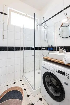 a washing machine in a bathroom with a shower at Prague Days - Studio with Netflix in Old Town in Prague