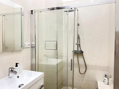 a bathroom with a glass shower and a sink at Entire unit in the center of Prague in Prague