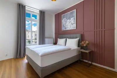 a bedroom with a large white bed and a window at Encore Boutique Residence by Dwellfort in Prague