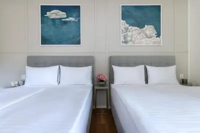 two beds sitting next to each other in a bedroom at Encore Boutique Residence by Dwellfort in Prague