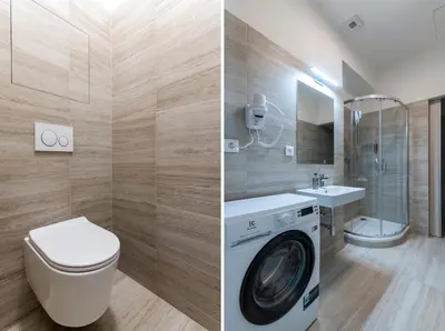a bathroom with a washing machine and a washer and dryer at Encore Boutique Residence by Dwellfort in Prague