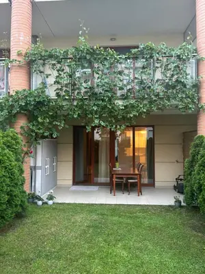 a house with a patio with a table on a lawn at Pegas Apartments in Prague