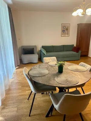 a living room with a table and chairs and a couch at Pegas Apartments in Prague
