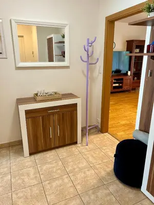 a living room with a cross on a counter and a mirror at Pegas Apartments in Prague
